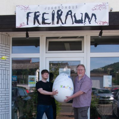 Zwei Männer tragen ein Ei